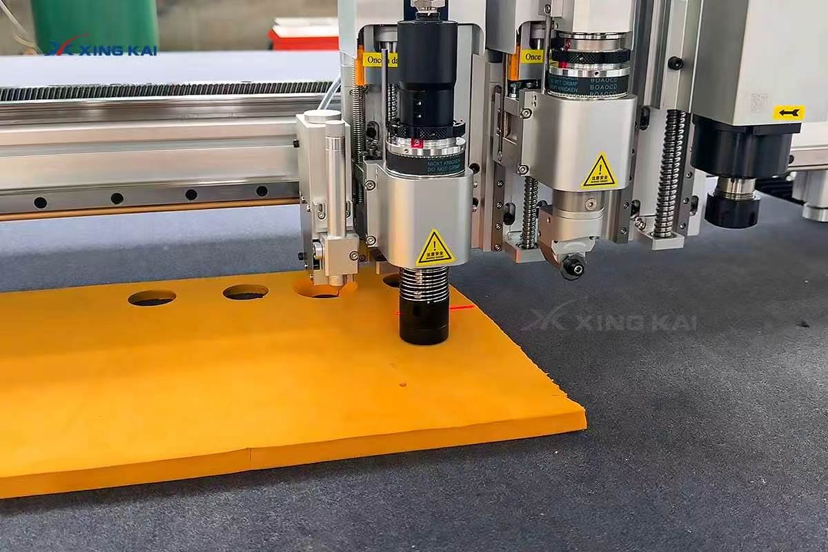 CNC oscillating knife cutting an orange EVA foam sheet