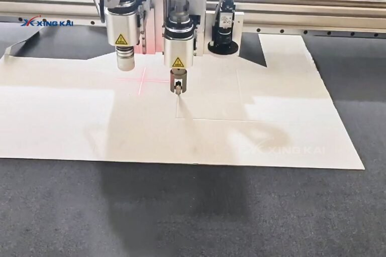 CNC oscillating knife cutting a cardboard folding box blank