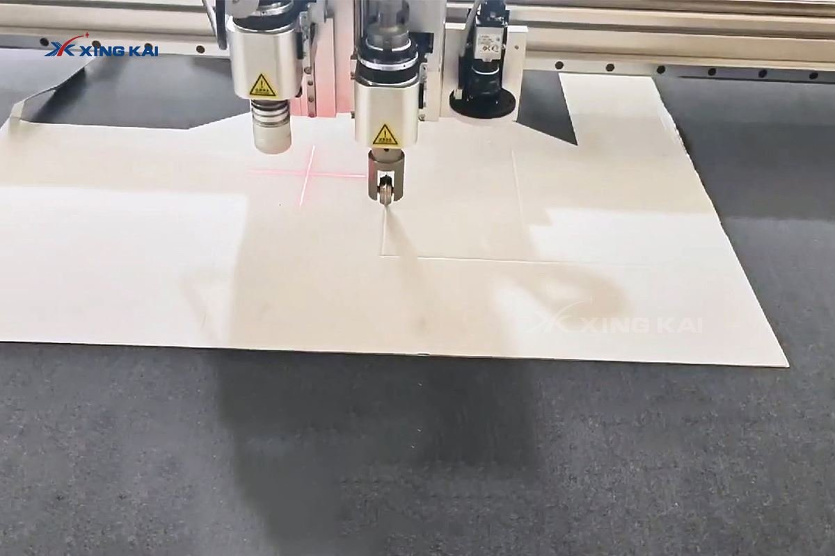 CNC oscillating knife cutting a cardboard folding box blank