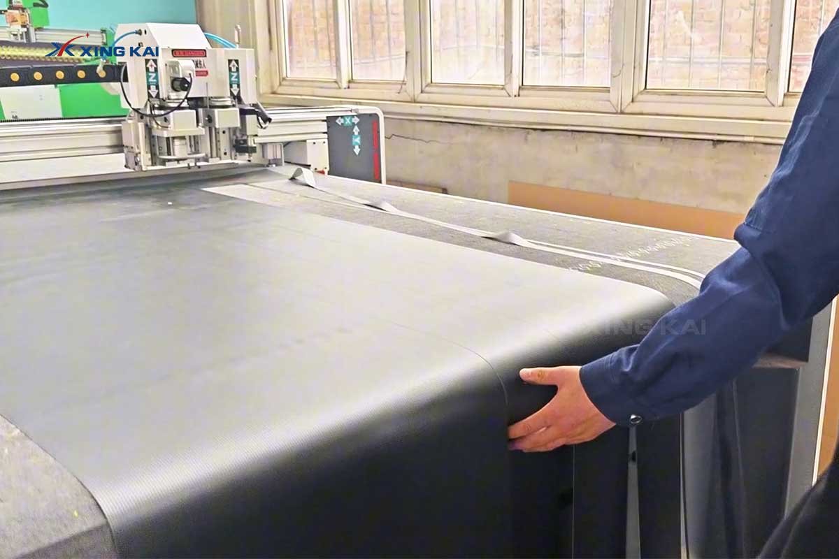 Carbon fiber roll loaded on a Xingkai CNC oscillating knife cutting machine
