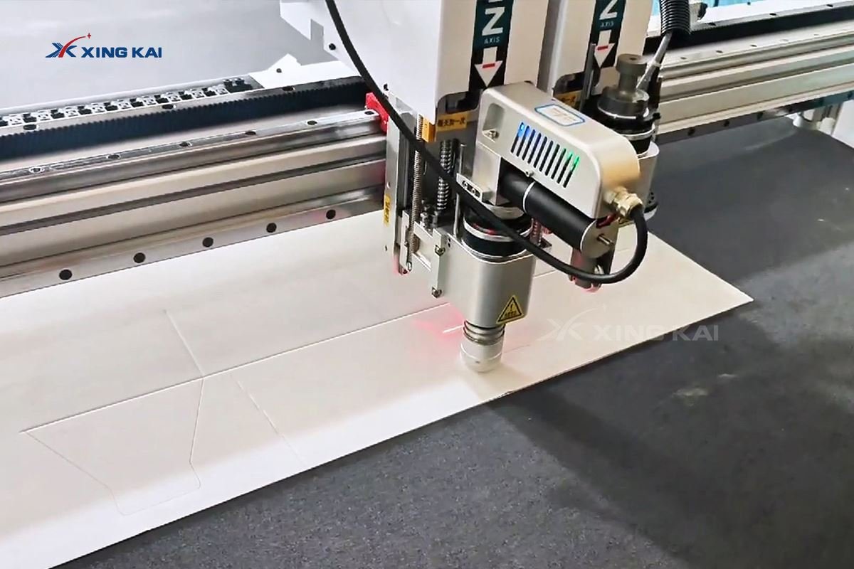 Multi-tool CNC cutting head processing a cardboard box pattern