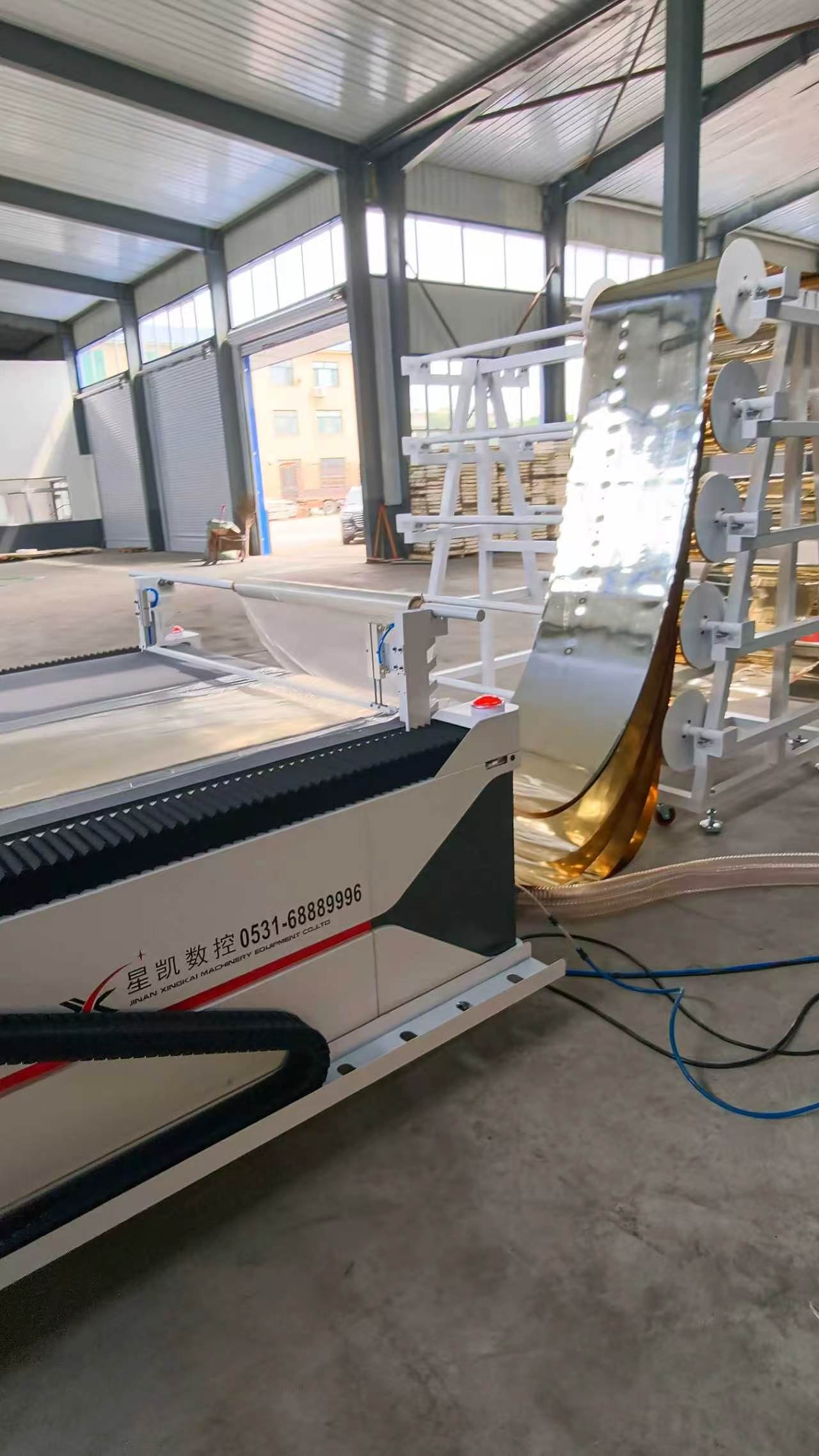 CNC oscillating knife cutting table with roll-fed reflective sequin material