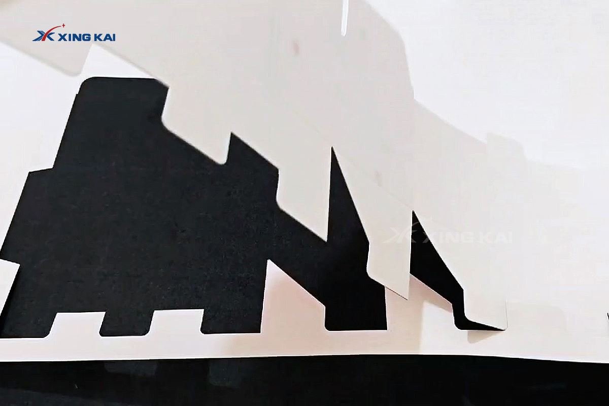 Cut white cardboard carton blanks on a digital cutting table